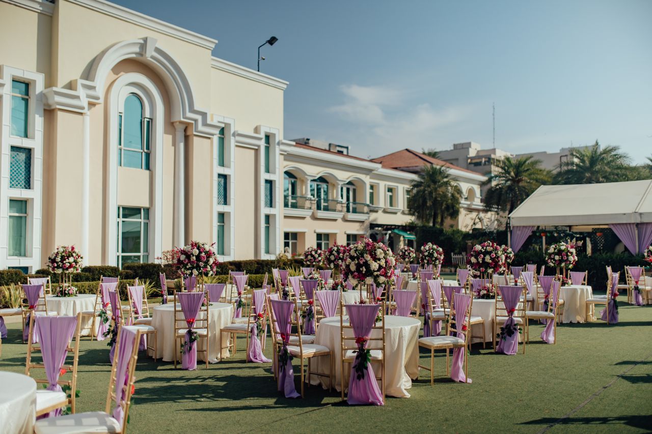 Luxurious outdoor wedding reception with floral arrangements and elegant decor.